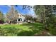 Expansive backyard with a lush green lawn and mature trees providing shade and privacy for outdoor enjoyment at 11321 Mesa Verde Pl, Parker, CO 80138