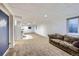 Spacious basement features large entertainment area with plush carpeting and a wet bar for entertaining at 11321 Mesa Verde Pl, Parker, CO 80138