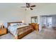Bright bedroom features a wooden bed frame, side tables and an adjacent bathroom at 11321 Mesa Verde Pl, Parker, CO 80138