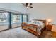 Comfortable bedroom with ceiling fan, large windows, and neutral decor at 11321 Mesa Verde Pl, Parker, CO 80138
