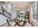 Elegant dining room featuring a glass-top table, stylish chairs, and a staircase at 11321 Mesa Verde Pl, Parker, CO 80138
