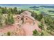 Aerial view of secluded mountain home surrounded by lush trees and spectacular views at 13084 Deer Ridge Way, Larkspur, CO 80118