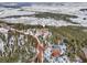 Aerial shot of home on a snowy hill surrounded by trees at 13084 Deer Ridge Way, Larkspur, CO 80118