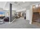 Finished basement area includes workout equipment and a stairway at 13084 Deer Ridge Way, Larkspur, CO 80118