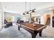 Spacious basement area with a pool table, comfortable seating, and exercise equipment at 13084 Deer Ridge Way, Larkspur, CO 80118