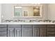 A well lit bathroom featuring double sinks, neutral tile, and modern hardware at 13084 Deer Ridge Way, Larkspur, CO 80118