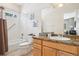 Full bathroom with shower and tub combination plus a wooden vanity at 13084 Deer Ridge Way, Larkspur, CO 80118