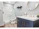 Bathroom featuring a tiled shower, modern vanity with gold hardware, and round mirror at 13084 Deer Ridge Way, Larkspur, CO 80118