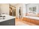 Spacious bathroom includes walk-in shower, soaking tub, and large vanity at 13084 Deer Ridge Way, Larkspur, CO 80118