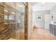 Stunning bathroom featuring a stone tiled shower with glass door and earth tone tile flooring at 13084 Deer Ridge Way, Larkspur, CO 80118