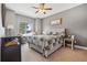 Inviting bedroom with large window, ceiling fan, and neutral decor at 13084 Deer Ridge Way, Larkspur, CO 80118