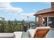 Outdoor deck with lounge seating overlooking the mountain views at 13084 Deer Ridge Way, Larkspur, CO 80118