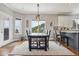 Dining area features hardwood floors, a mountain view, and opens up to the kitchen and living area at 13084 Deer Ridge Way, Larkspur, CO 80118