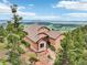 Hillside home with clay tile roof and stunning views of the surrounding landscape at 13084 Deer Ridge Way, Larkspur, CO 80118