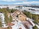 Aerial view of home surrounded by forest with long driveway in winter at 13084 Deer Ridge Way, Larkspur, CO 80118