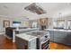 Spacious open concept kitchen with a center island cooktop connected to the living room with a fireplace at 13084 Deer Ridge Way, Larkspur, CO 80118