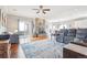 Open living room features a stone fireplace, hardwood floors, and sliding glass doors to the outdoors at 13084 Deer Ridge Way, Larkspur, CO 80118