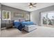Spacious main bedroom features a ceiling fan, large windows, and outside access at 13084 Deer Ridge Way, Larkspur, CO 80118