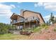 Exterior of home showing spacious decks and patio areas, perfect for outdoor living at 13084 Deer Ridge Way, Larkspur, CO 80118