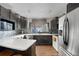 Modern kitchen with dark cabinetry and white countertops at 2220 S Linley Ct, Denver, CO 80219