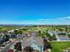 Scenic aerial view of a community with green spaces, blue buildings, and mountain views at 2550 S Cutters Cir # 105, Castle Rock, CO 80108