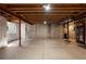 Unfinished basement with concrete walls and floor, featuring exposed ductwork and utilities at 2550 S Cutters Cir # 105, Castle Rock, CO 80108