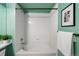 Clean, tiled bathroom features a shower-tub combination and modern fixtures and white tile walls at 2550 S Cutters Cir # 105, Castle Rock, CO 80108