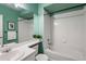 Bright bathroom features a sink, toilet, shower-tub combo, and refreshing light green painted walls at 2550 S Cutters Cir # 105, Castle Rock, CO 80108