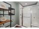 Modern bathroom with a glass shower door, an industrial shelf, and white tiled walls at 2550 S Cutters Cir # 105, Castle Rock, CO 80108