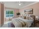 Cozy bedroom featuring a metal frame bed, plush pillows, and a large window with natural light at 2550 S Cutters Cir # 105, Castle Rock, CO 80108