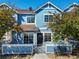 Charming blue two-story townhome with a small fenced yard and well-manicured landscaping at 2550 S Cutters Cir # 105, Castle Rock, CO 80108