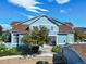 Inviting blue townhouse with a stone staircase, manicured shrubs, and a cozy front porch at 2550 S Cutters Cir # 105, Castle Rock, CO 80108