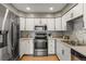 Modern kitchen featuring stainless steel appliances, white cabinets, and backsplash at 2550 S Cutters Cir # 105, Castle Rock, CO 80108