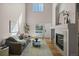 Bright living room featuring a fireplace, high ceilings, and hardwood floors at 2550 S Cutters Cir # 105, Castle Rock, CO 80108