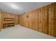 Basement room with wood paneling, carpeted floor, and built-in shelves at 28630 Pine Dr, Evergreen, CO 80439