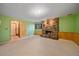 Basement featuring a stone fireplace, carpeted floor, and door to the utility area at 28630 Pine Dr, Evergreen, CO 80439