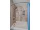 Close-up of tiled shower area with a rain shower head and integrated shelving at 28630 Pine Dr, Evergreen, CO 80439
