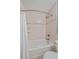 Bright bathroom featuring a white tiled shower with glass shelving and a chrome showerhead, with a shower curtain at 28630 Pine Dr, Evergreen, CO 80439