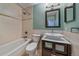 Well-lit bathroom featuring a tub, toilet, and modern vanity with ample storage and decorative mirror and backsplash at 28630 Pine Dr, Evergreen, CO 80439