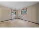 Cozy bedroom with neutral walls, carpet, two windows, and wood trim at 28630 Pine Dr, Evergreen, CO 80439