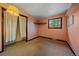 Cozy bedroom featuring neutral carpet, closet with curtains, and window views at 28630 Pine Dr, Evergreen, CO 80439