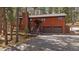 Charming home featuring an attached two-car garage and rustic exterior in a wooded area at 28630 Pine Dr, Evergreen, CO 80439