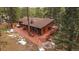 Stunning elevated view of a charming home with a spacious deck and inviting outdoor seating at 28630 Pine Dr, Evergreen, CO 80439