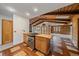 Kitchen area leading to a living space featuring wood ceiling and stainless steel appliances at 28630 Pine Dr, Evergreen, CO 80439