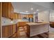 Bright kitchen with wooden cabinets, a butcher block island, and unique tiled flooring at 28630 Pine Dr, Evergreen, CO 80439