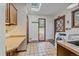 Bright laundry room features tile floor, skylight, wooden cabinets and exterior access at 28630 Pine Dr, Evergreen, CO 80439