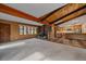 Open living area with wood paneled walls, wood beams, fireplace, and kitchen at 28630 Pine Dr, Evergreen, CO 80439