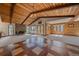 Open living area with wood paneled walls and tile flooring, with access to a balcony at 28630 Pine Dr, Evergreen, CO 80439