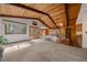 Spacious living room with wood-paneled ceiling, fireplace, and large windows at 28630 Pine Dr, Evergreen, CO 80439