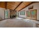 Bright living room with a stone fireplace and natural light streaming through the windows at 28630 Pine Dr, Evergreen, CO 80439